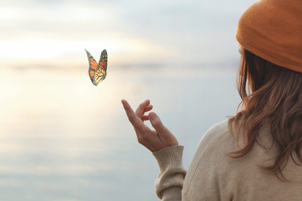 Butterfly off fingers of a woman