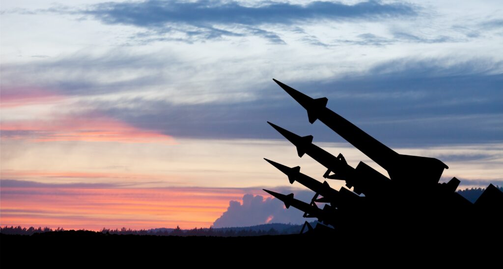 Missiles pointing to sky at sunset