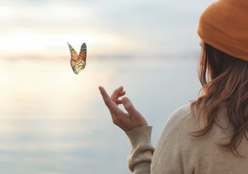 Butterfly off fingers of a woman