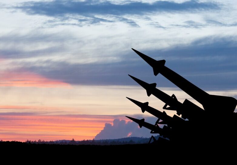 Missiles pointing to sky at sunset